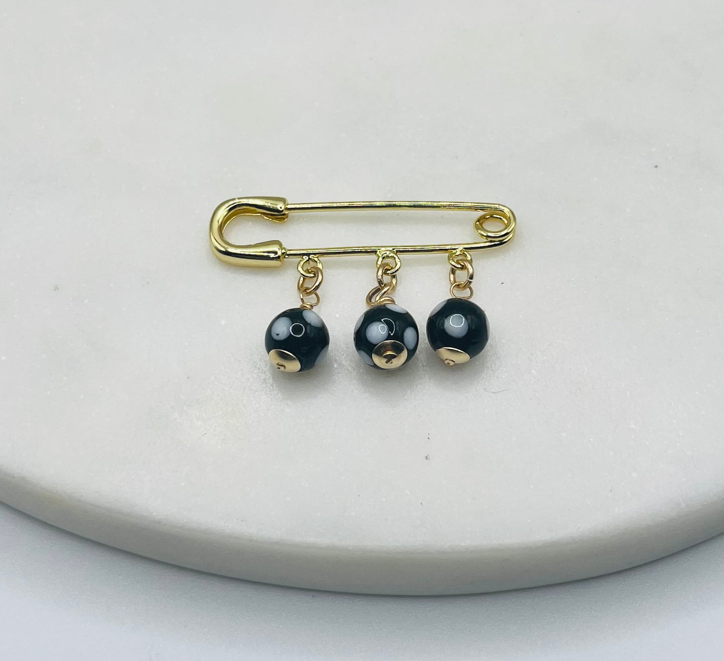 Conta di Ojo Safety Pin